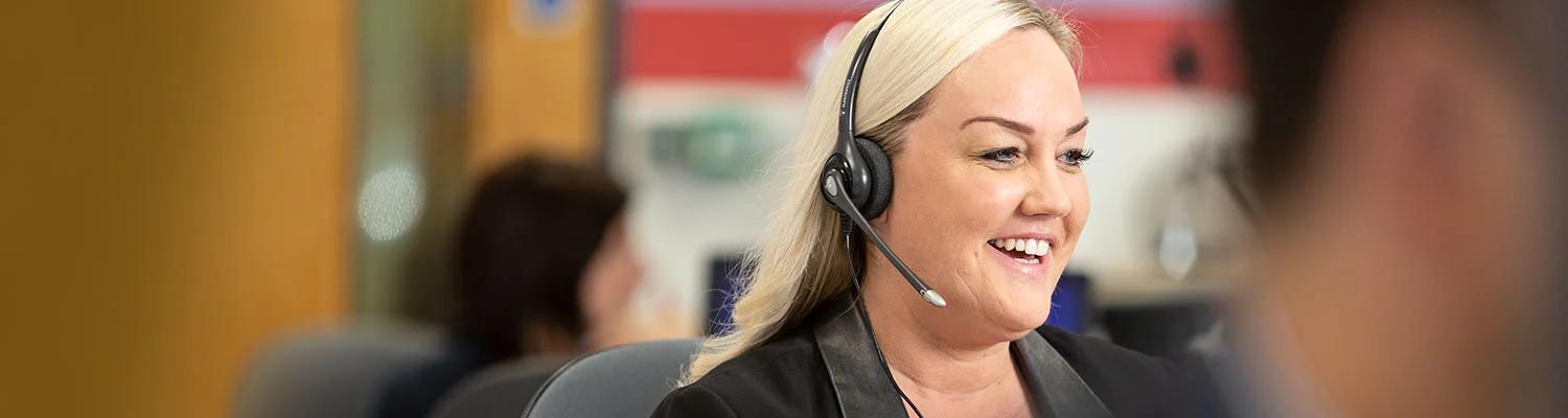 Happy call centre employee with a headset