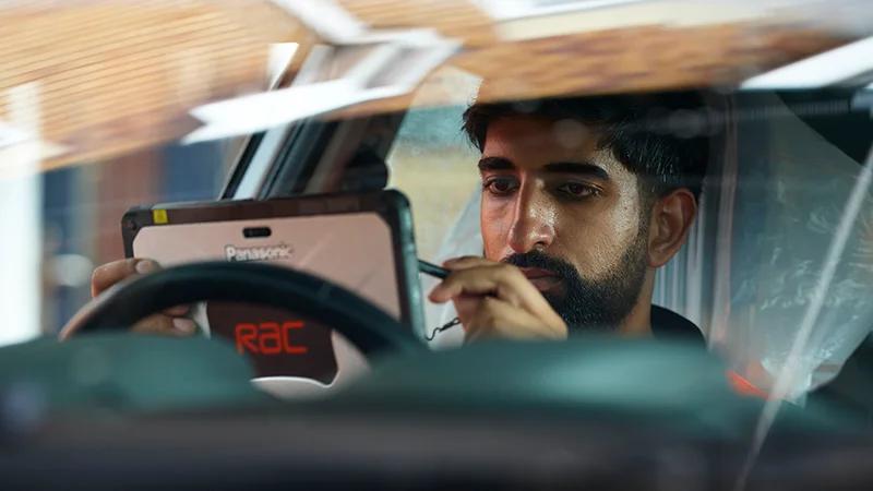 Close up of an RAC Mobile Mechanic running a vehicle diagnostic check