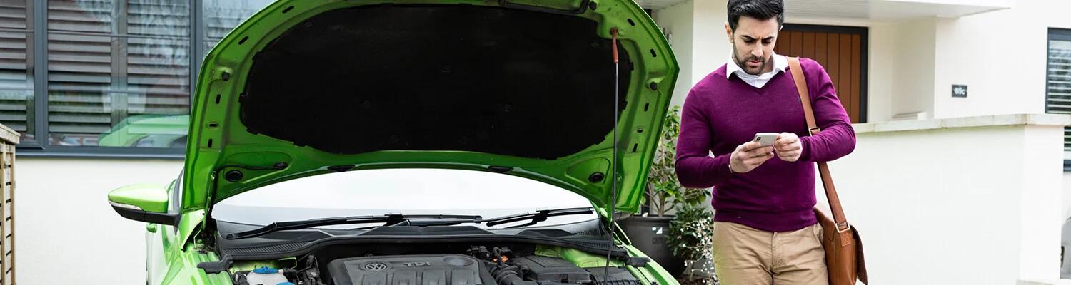 Man stood next to his car with the bonnet open