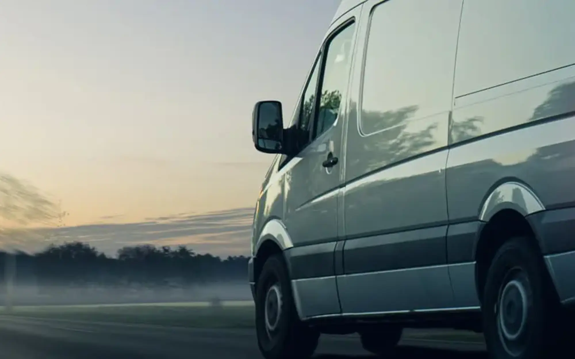 Van driving into sunset